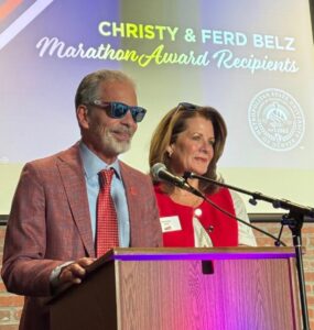 Christy and Ferd Belz receiving the Marathon Award from Metro State